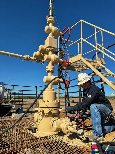 Downing employee performing preventive maintenance on a valve in the field